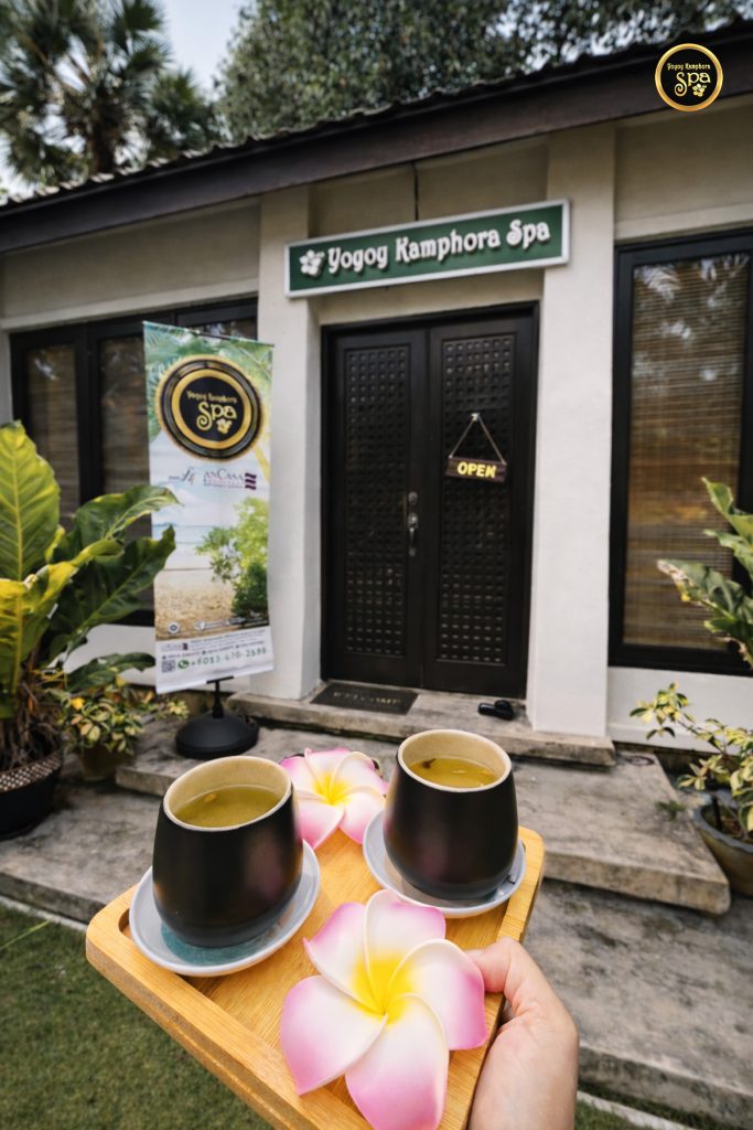 Spa welcome drinks served on a tray with frangipani flowers at Yoyoy Kamphora Spa AnCasa Resort Port Dickson entrance