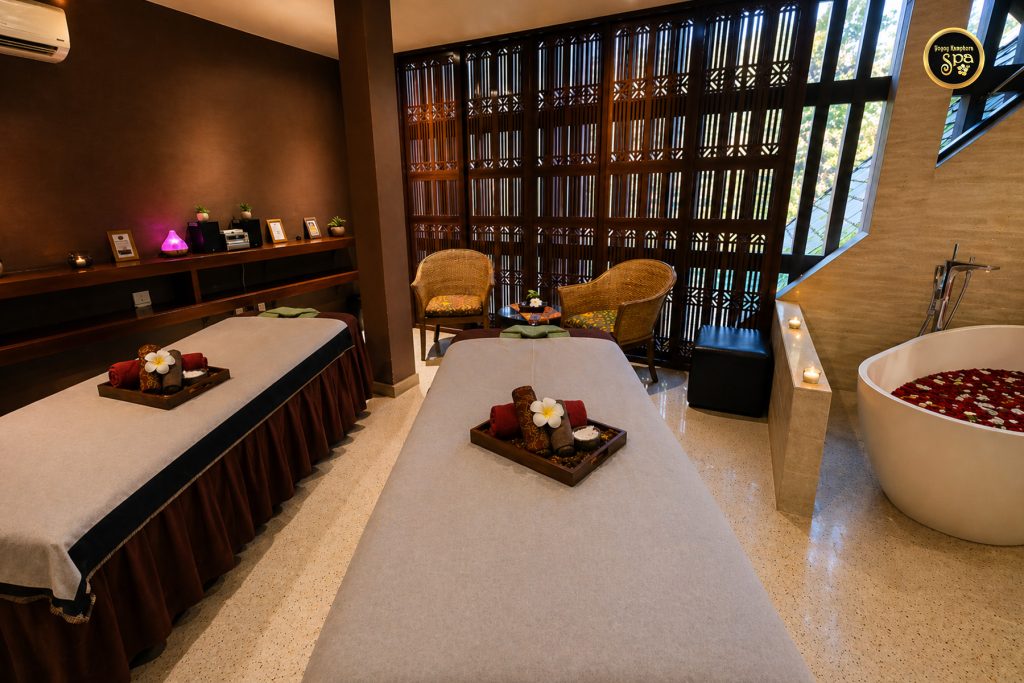 Luxury spa treatment room interior with massage beds and bathtub in Malaysia