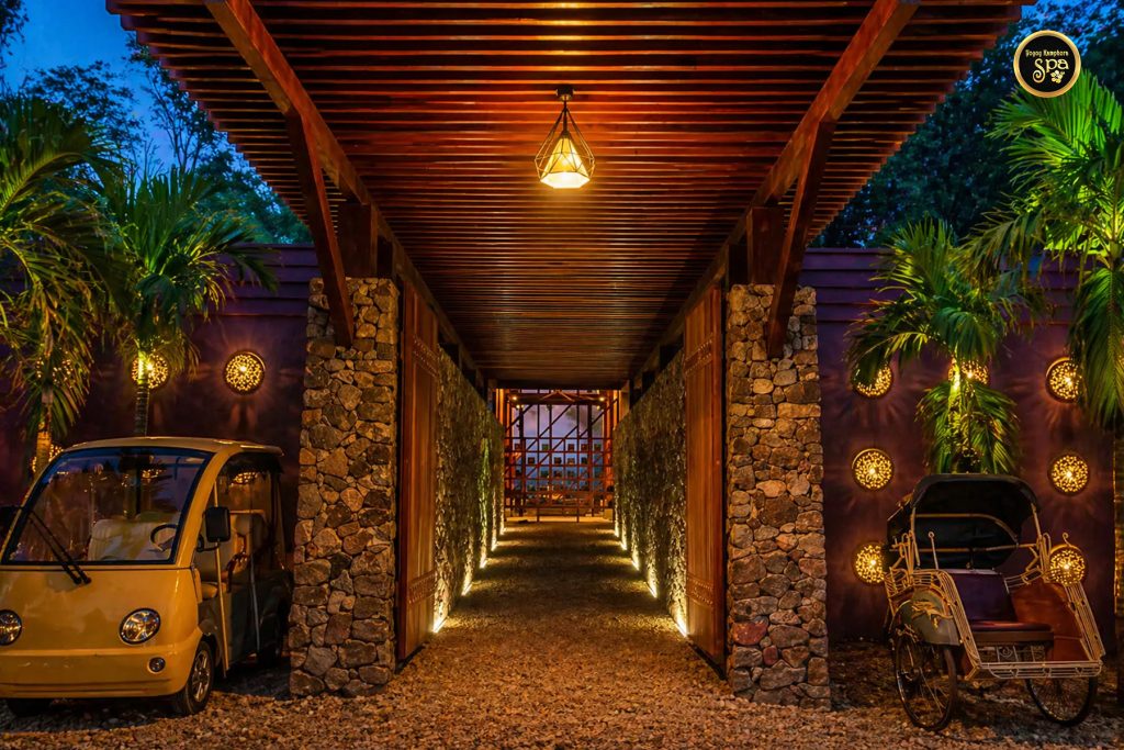Resort entrance walkway with warm lighting and traditional elements at spa Malaysia