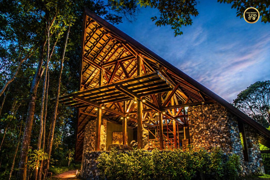Traditional wooden resort architecture illuminated at night in Malaysia spa resort