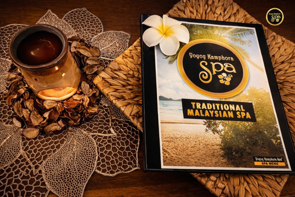 Yoyoy Kamphora Spa menu with candle and decorative elements on wooden table